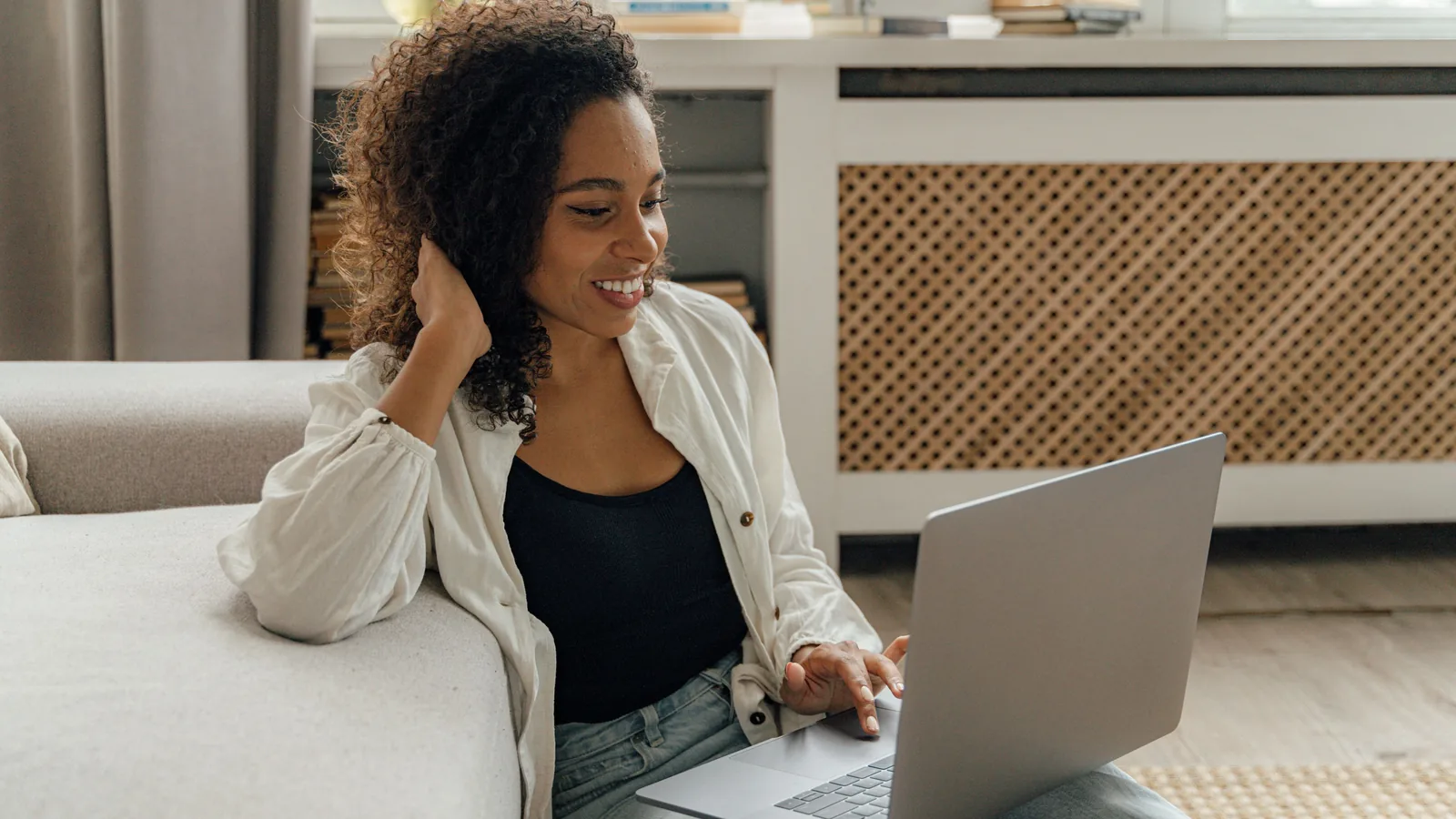 Woman comparing AmONE Loans personal loan offers on a laptop